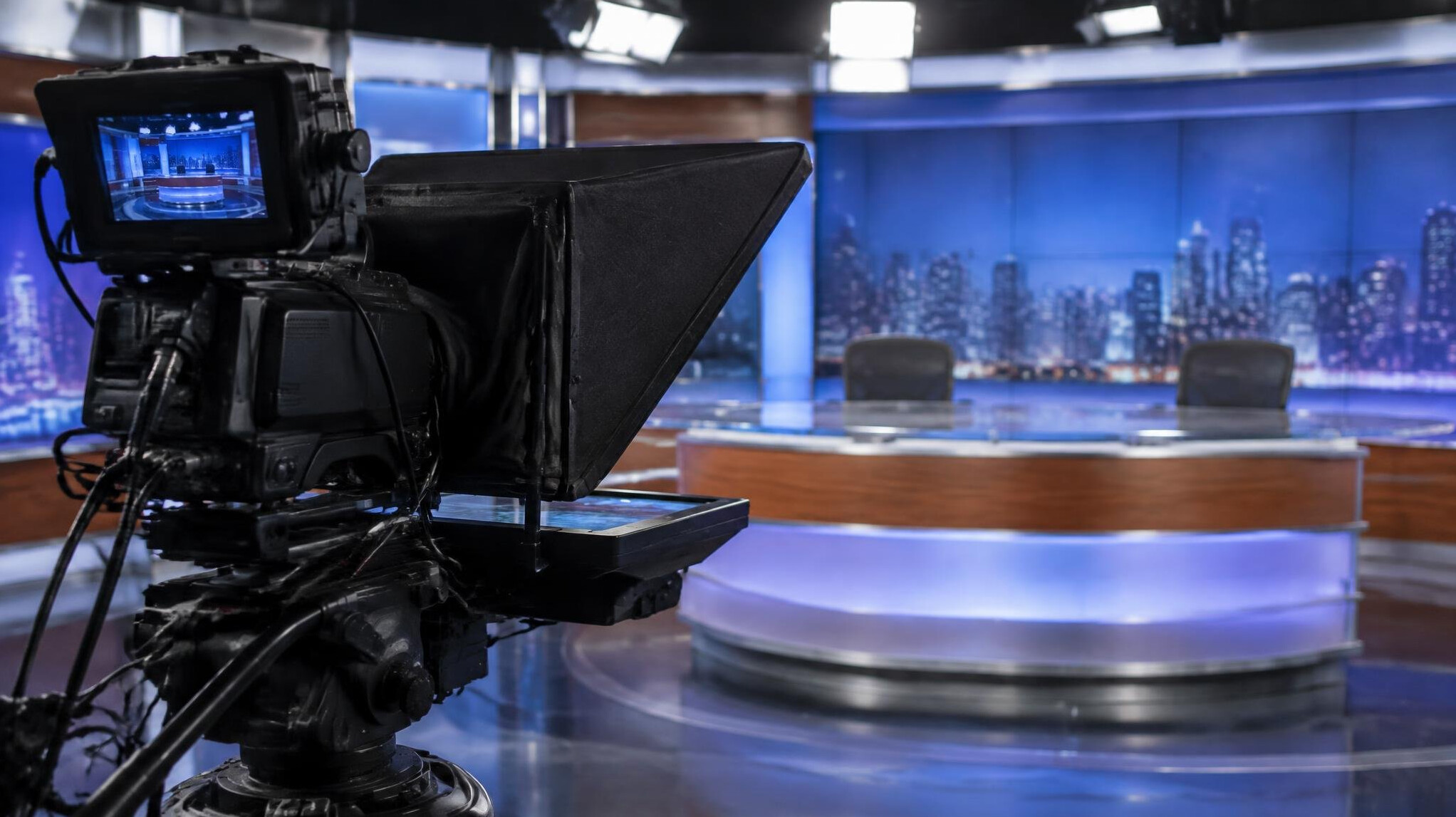 Teleprompter mounted in front of a broadcast camera on set