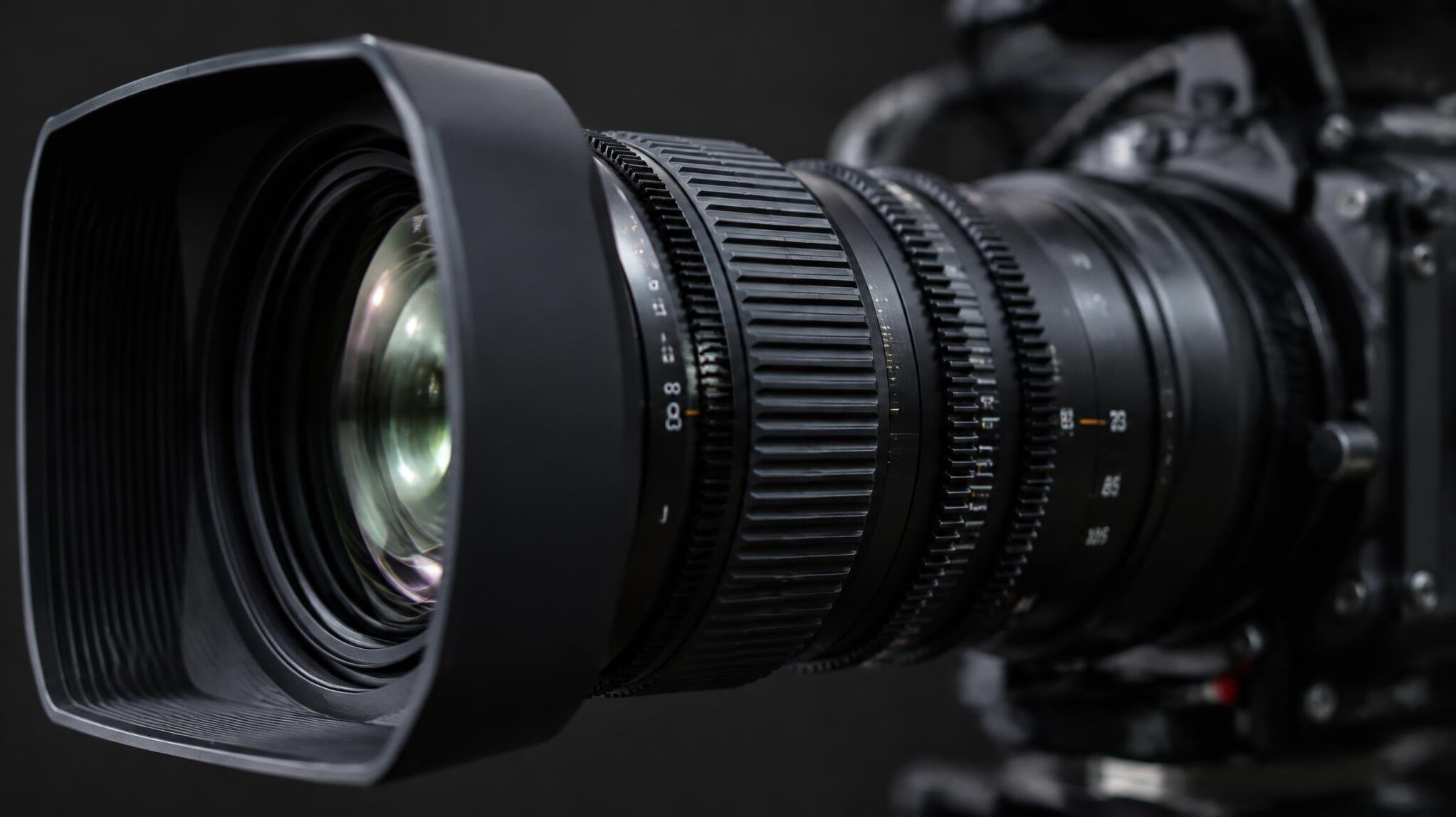 Close up of a broadcast camera lens with focus rings