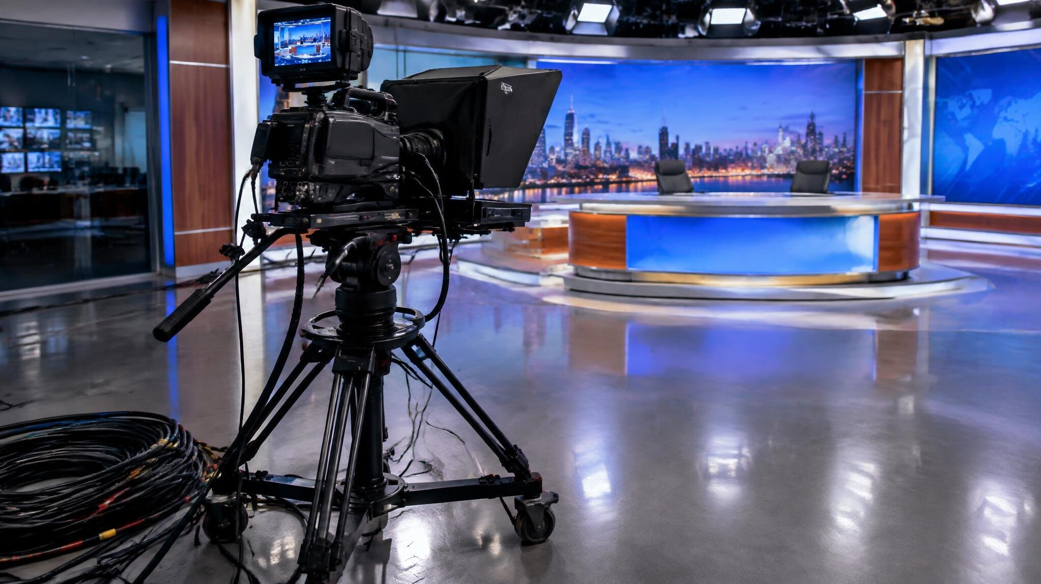 Broadcast camera and tripod positioned on a television studio floor