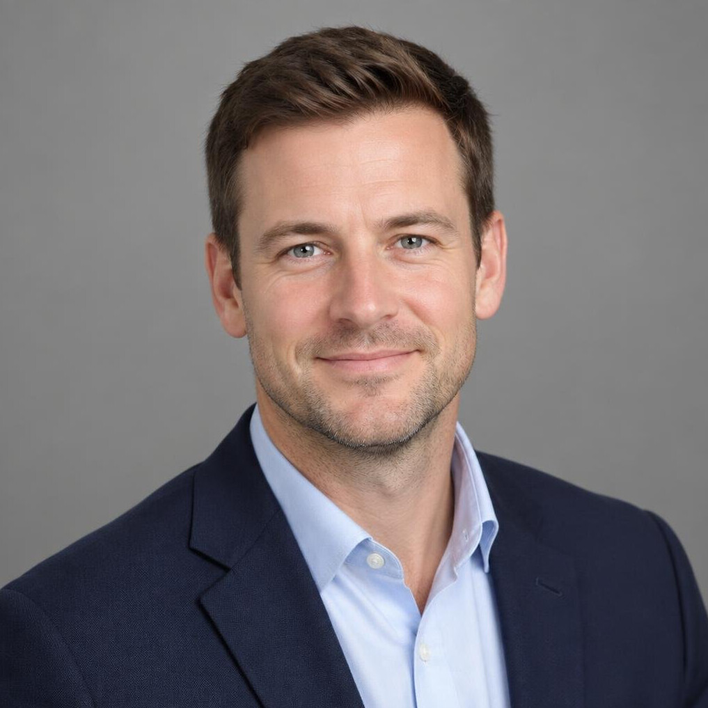 Studio portrait of a British man in his thirties wearing a blazer